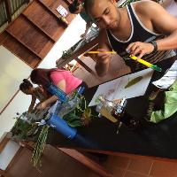 Students do fieldwork in a classroom with various plant life on a lab counter.