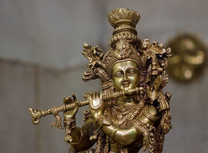 Bronze statue of Krishna playing a flute.