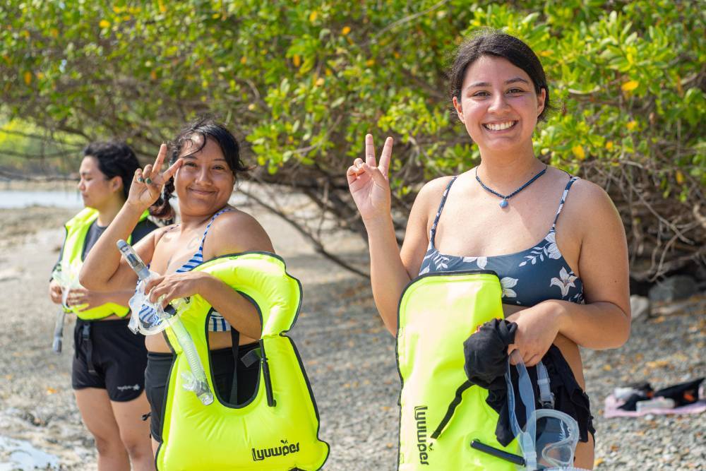 Female students getting ready for an activity in the water. 