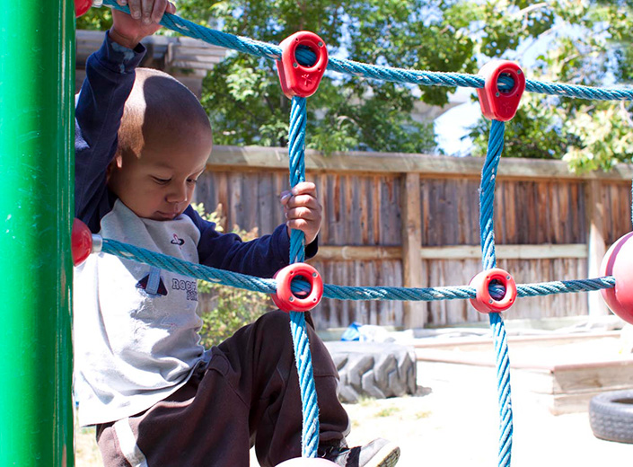 little boy climbing ropes