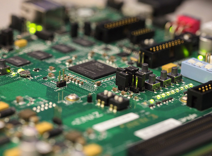 An exposed circuit board is displayed on a table.