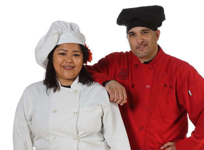 Two Hospitality Management students in uniform.