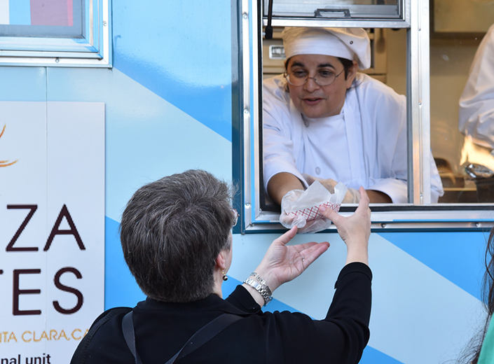 woman handing out food