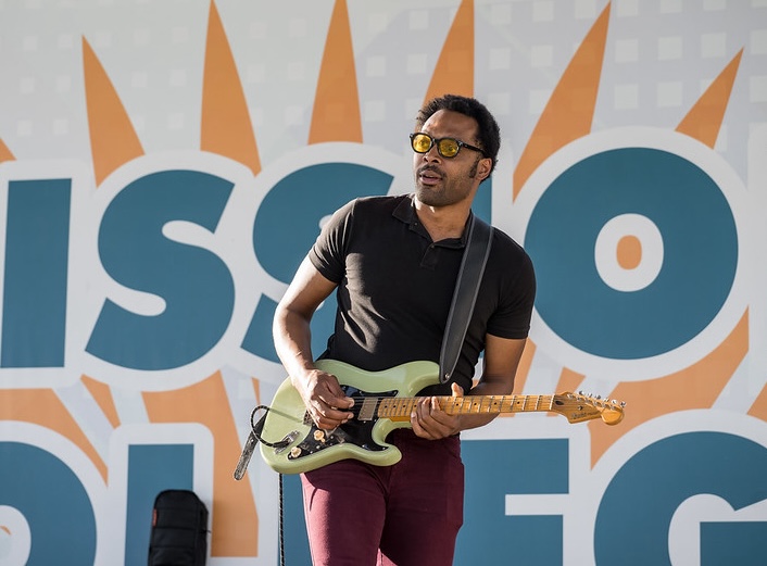 Man plays electric guitar.