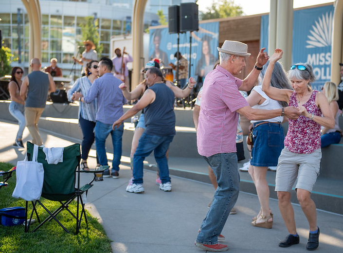 Evening scene of guests enjoying live music at the Mission College concert