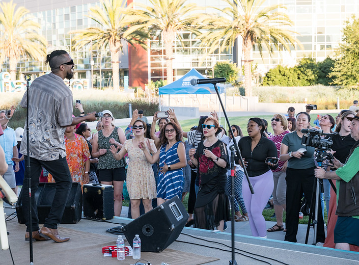 Lead singer passionately performing on stage at Mission College Summer Concert Series