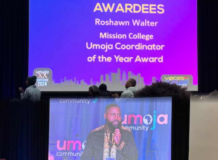 Image of award recipient on TV screen