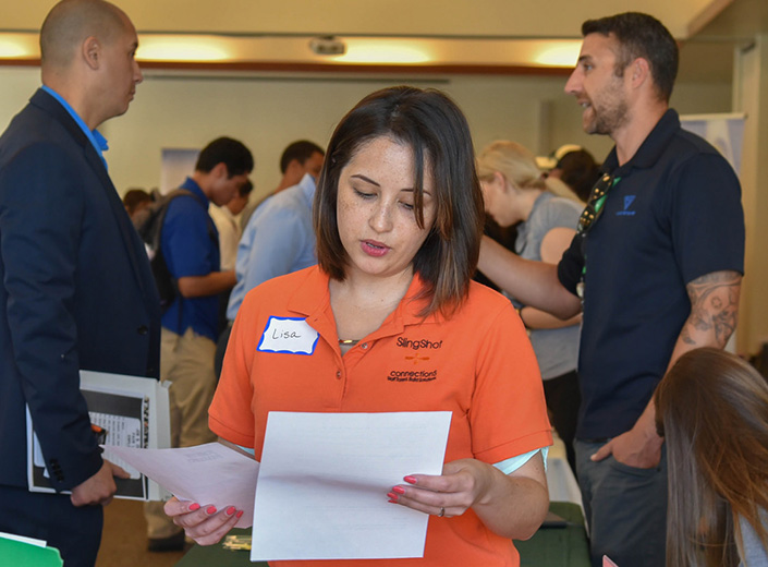 students talking to an employer