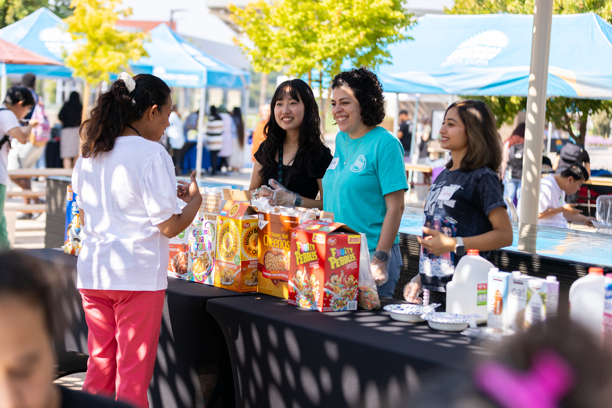 Student government speaking to student at basic needs fair