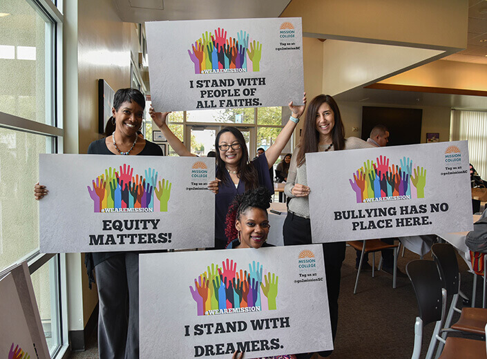 women holding signs promoting equity