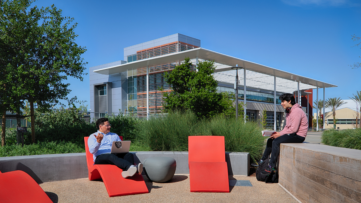 Student and employee talking on campus