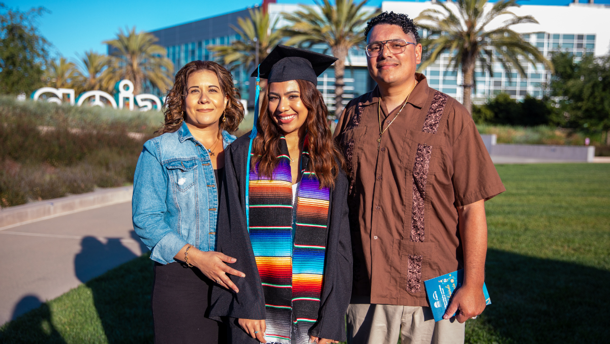 Smiling student with family at graduation event