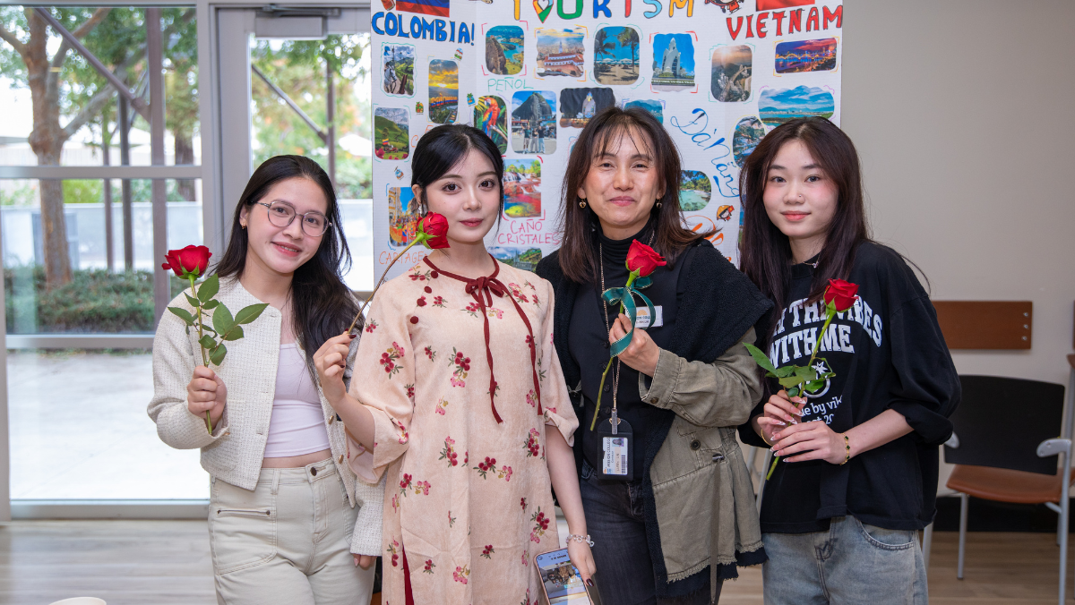 Four students smiling at event