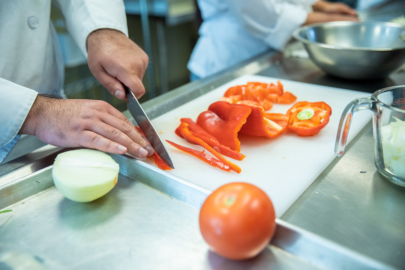 Culinary Student cutting 