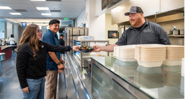 Dining staff serving bowl
