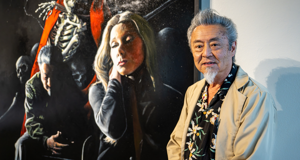 Artist in front of painting