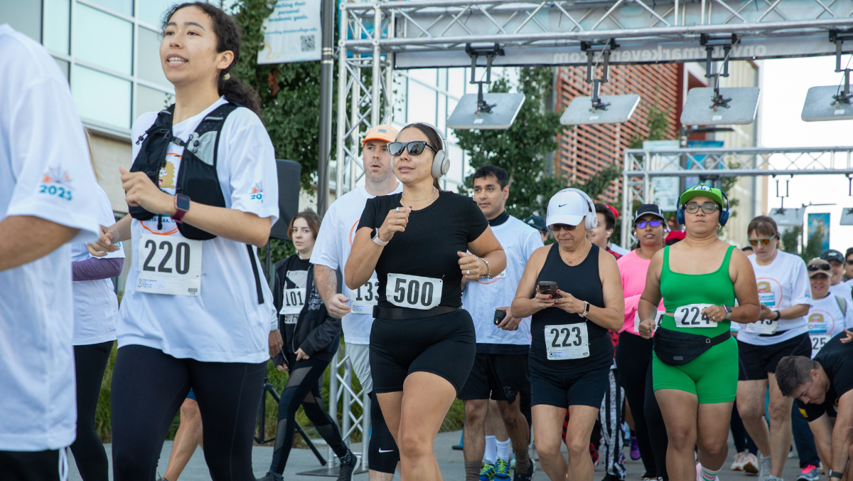 Participants of all ages begin the Monster Dash & Bash 5K as they cross the starting line on the Mission College campus.