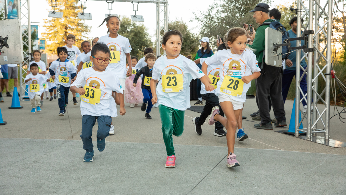 Children race across the starting line during the Kids Fun Run at the Monster Dash & Bash 5K event.