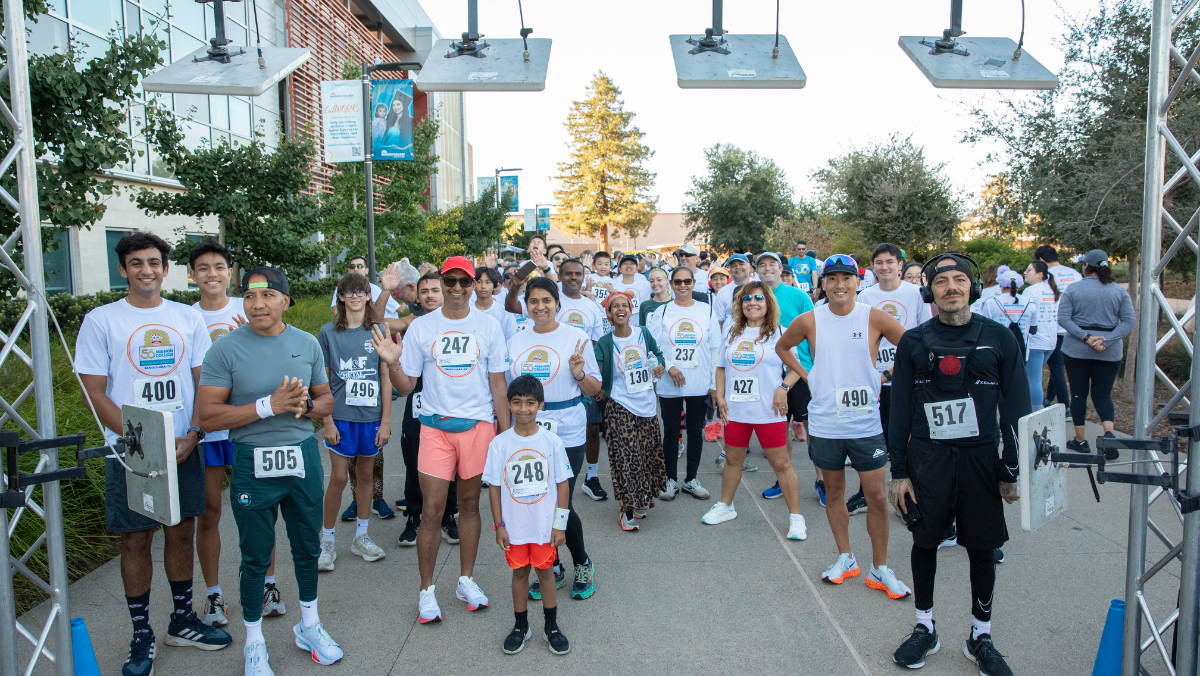 Participants of all ages begin the Monster Dash & Bash 5K as they cross the starting line on the Mission College campus.