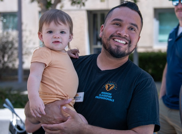 Classified staffer with baby.