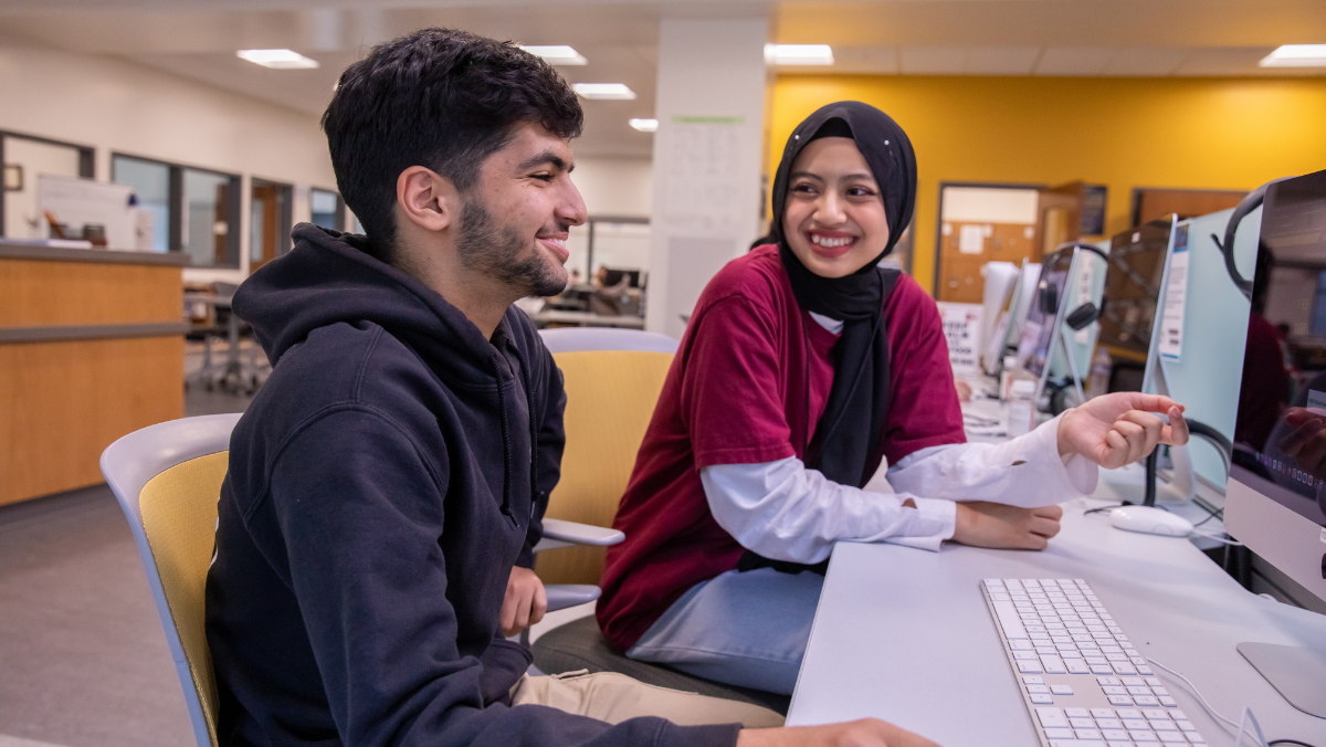 Smiling students working together in classroom