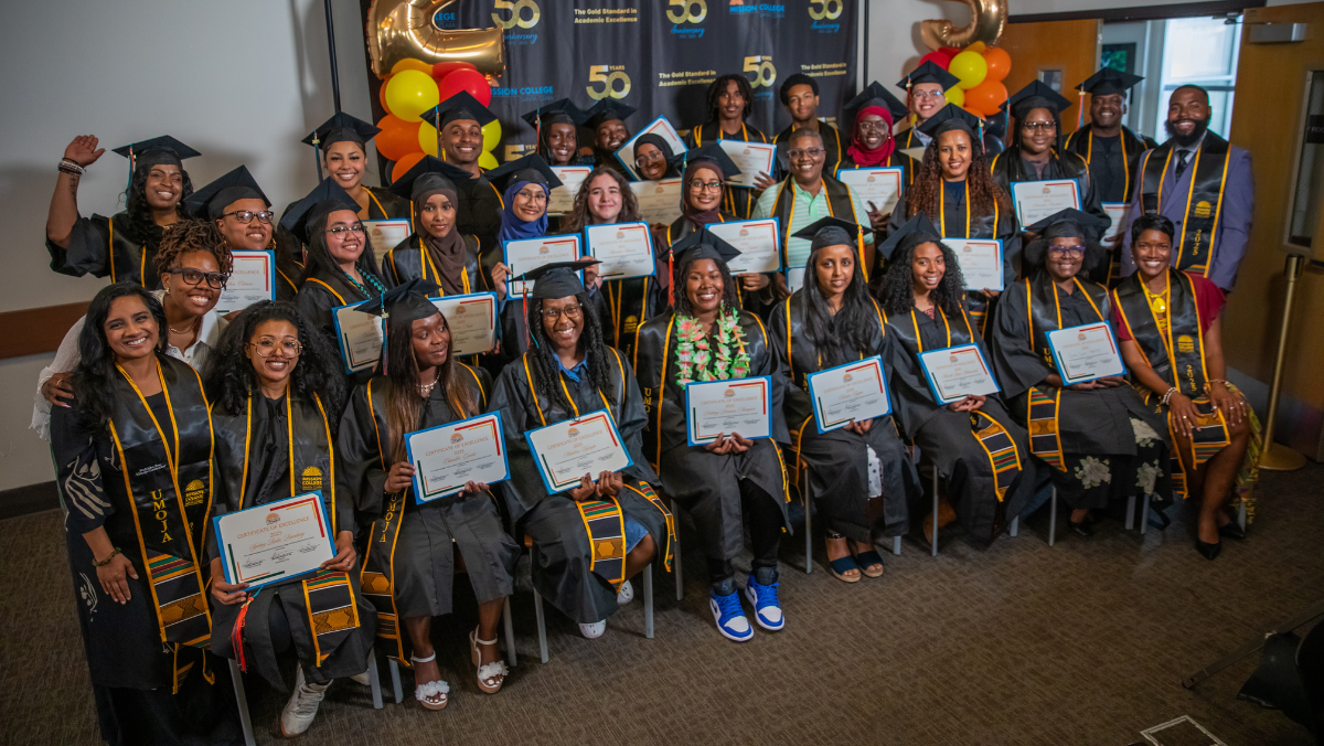 Graduates smiling in building