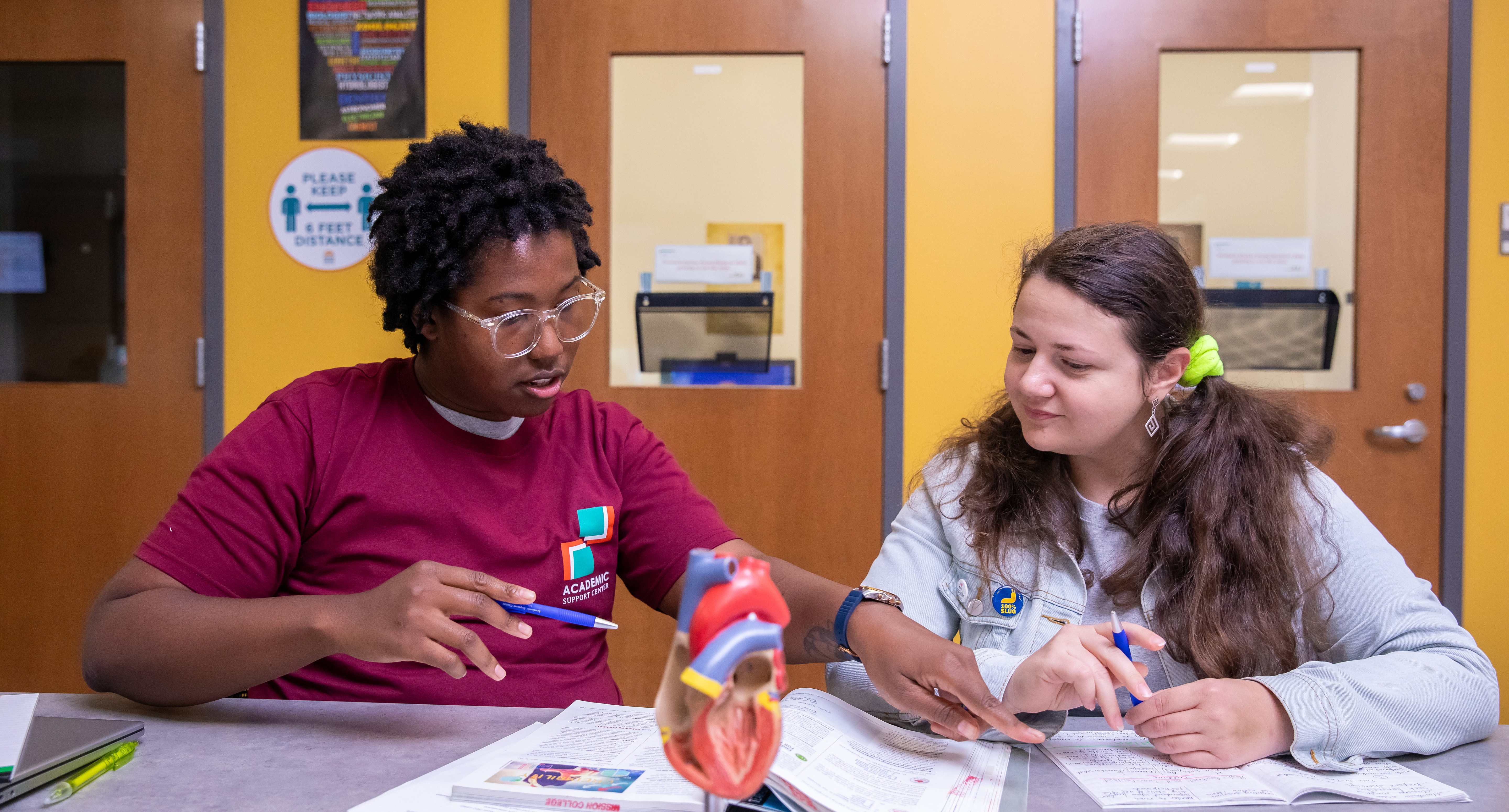Tutor helping another student