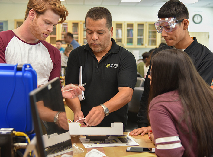 HSI-STEM students working with LatinX instructor in a lab.