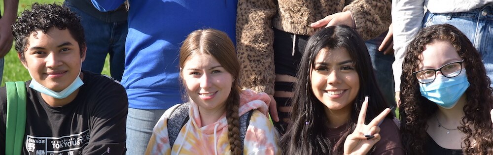 International Students at International Week at Mission College. Four students sit together.