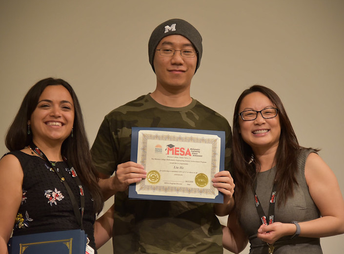 MESA students with Thuy Trang, a counselor holding certificate of completion.