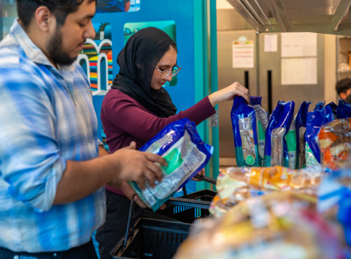 Students looking at food in the Mission Market