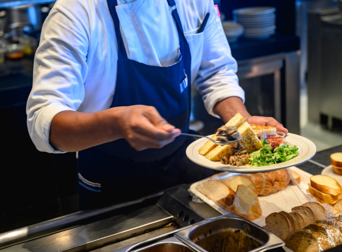 Cafeteria worker serving food 