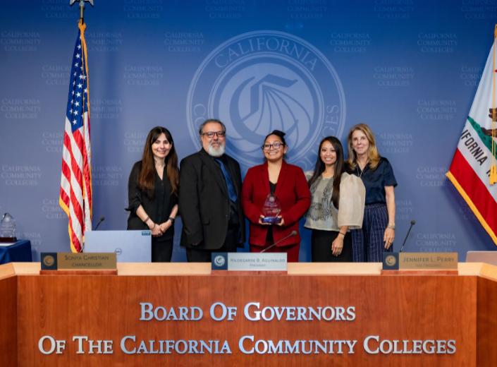Dr. Lusyna Kim-Narvaez receives the 2026 California Community Colleges Classified Employee of the Year Award during the California Community Colleges Board of Governors meeting in Sacramento, joined by colleagues and state leaders.