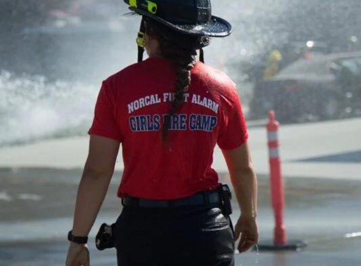 Female firefighter looking at fire